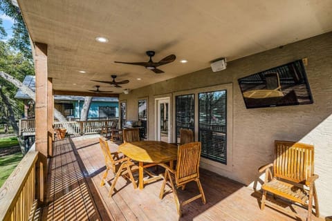 Enjoy the outdoors in comfort — spacious deck with a TV and cozy seats.