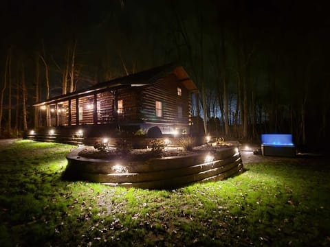 Our log cabin under the lights! Enjoy the hot tub late into the evening under the lights!