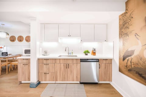 The bright lighting and open design make it a welcoming space for cooking or gathering. Perfect for preparing meals and enjoying the comforts of home during your stay.