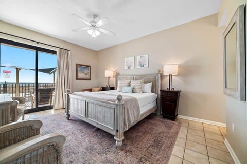 Primary bedroom: Cozy lightly accented bedroom with a sliding patio window showcasing stunning views