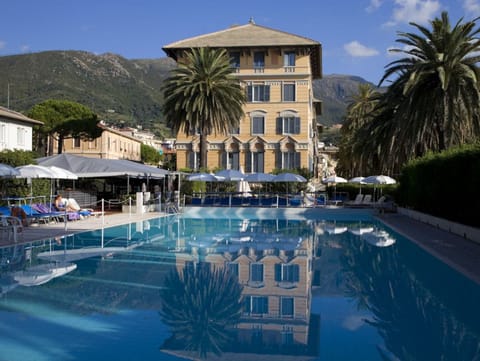 Seasonal outdoor pool, open 9:00 AM to 7:00 PM, pool umbrellas