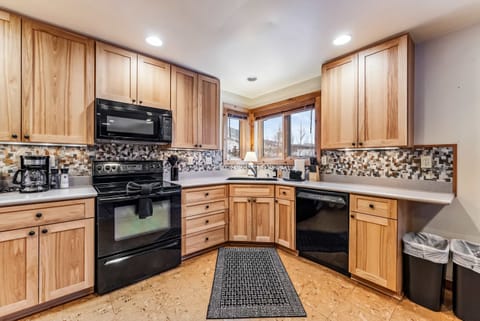 Kitchen: Drip coffee maker, Crockpot, toaster, cooking utensils, tableware