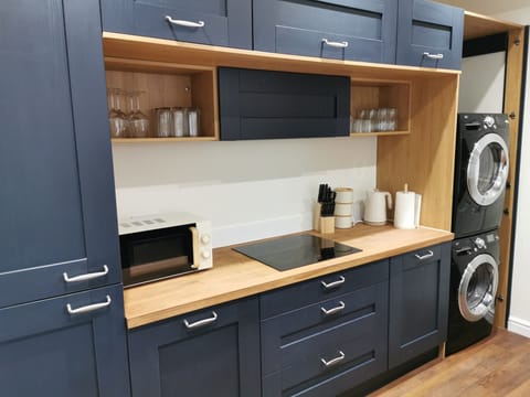Kitchen showing hob, washing machine and tumble dryer