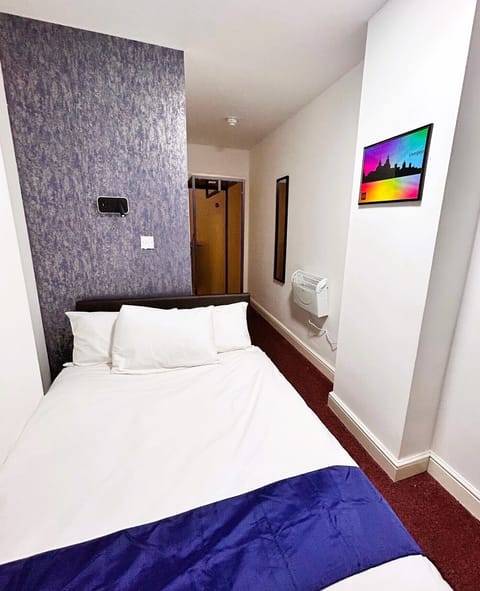 Economy Double Room | Desk, laptop workspace, blackout drapes, iron/ironing board