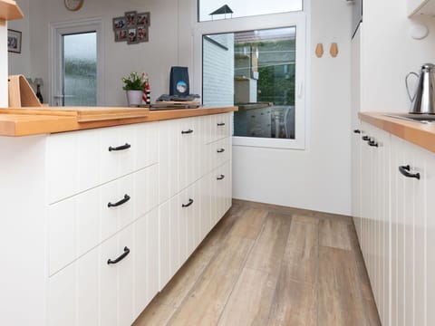 Countertop, Cabinetry, Kitchen, Flooring, Furniture, Wood, Interior Design, Floor, Kitchen Appliance, Drawer