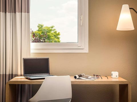 Premium bedding, desk, laptop workspace, blackout drapes