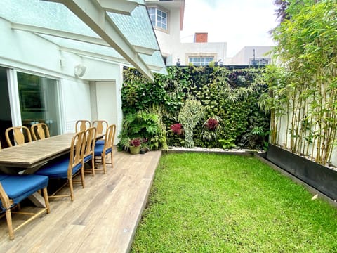 Garden outside with green wall, table for 10 people