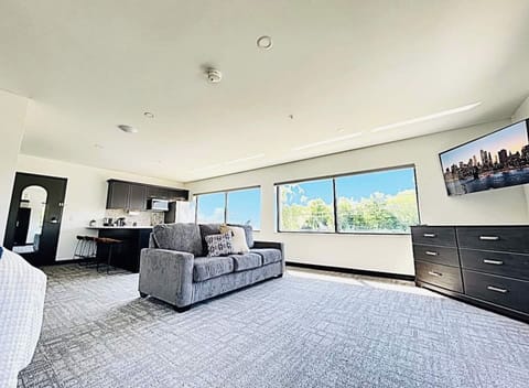Unwind in this bright corner nook, complete with a dresser and a mounted TV for your favorite shows. Large windows offer plenty of daylight and neighborhood views.