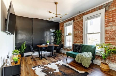 kick back in our cozy jungle-themed living room with smart tv & real plants designed for connection & comfort, this living room is the heart of the home!