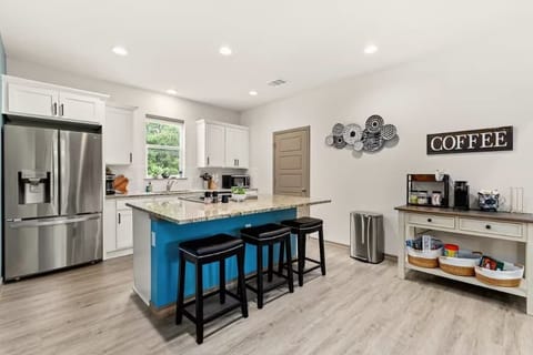 Modern kitchen with bar seating and coffee nook.