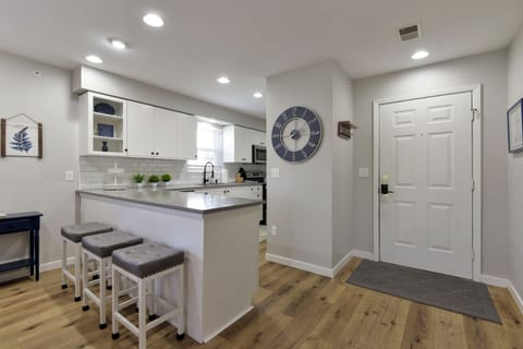 Front Entry and Kitchen with bar area and bar stools. 