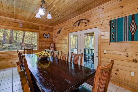Gather around the stunning long table with forest views—perfect for feasts and laughter!
