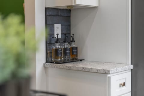 A symphony of style!  The warm wood floors, rich rug, and sleek white cabinets create a sophisticated and inviting space.  Absolutely love it!