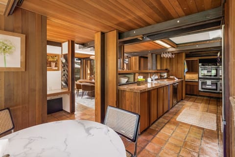 Rustic charm meets modern functionality! This warm, wood-accented kitchen features natural textures, ample counter space, and an inviting dining nook for cozy gatherings.