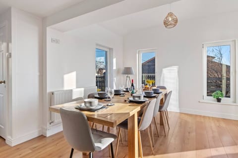 Swn y Don - Open-Plan Living and Dining Space A beautifully designed space combining the dining area and access to the lounge, with natural light flooding in through the large windows.