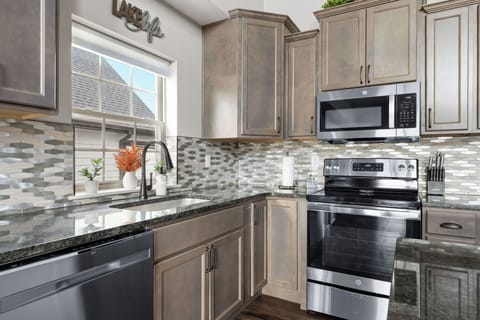 - Beautifully finished kitchen with stainless steel appliances & sleek tile backsplash
- Extra counter space & modern touches make meal prep easy & enjoyable
- You're whipping up a family feast or late night snacks, everything you need is here