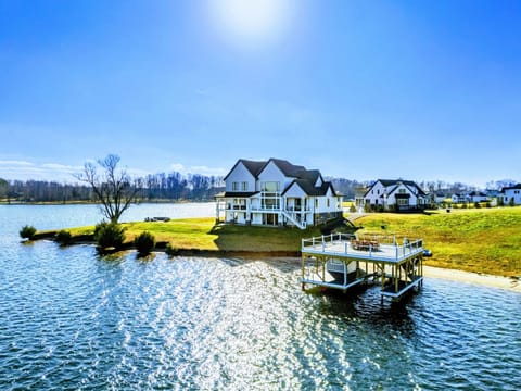 A stunning waterfront property features a spacious home with a private dock and panoramic views of the lake, perfect for relaxation and outdoor enjoyment.