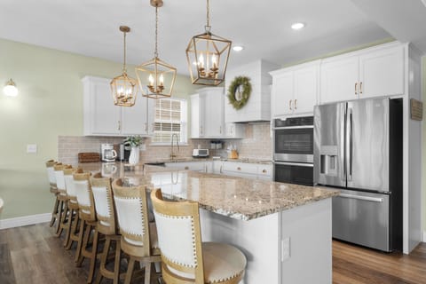 - Stylish kitchen, featuring sleek granite countertops and elegant finishes
- Enjoy the convenience of modern appliances, including a spacious double oven
- Gather around the large island with plenty of seating, perfect for casual dining