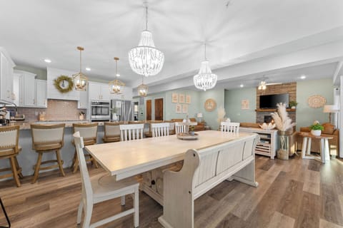 - Chef's dream kitchen with granite countertops, dual ovens, and a full breakfast bar
- Elegant lighting & charming dining set for shared meals and laughter
- Seamlessly connected to the living area, perfect for entertaining with ease