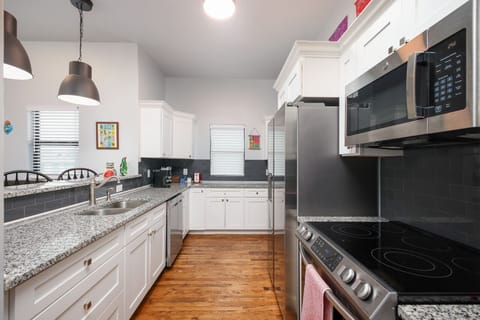 Stylish and functional kitchen with a gas stove, microwave and fridge.