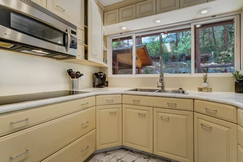 Upper Level Kitchen is equipped with a induction stove top and a convection oven.