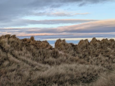 Over the Dunes there be the Sea, lapping at the Silvery Sands of the Beach