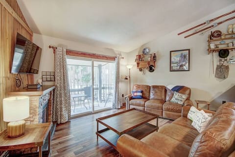Large gathering space with antique hutch, electric fireplace, Smart TV with cable, two amazing leather sofas- one with a queen bed, the other has two recliners for relaxing after a day in the mountains. Opens to a balcony with gas grill.