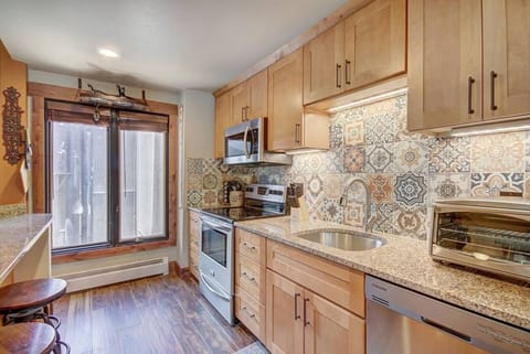 Be part of the conversation in this fully equipped galley kitchen overlooking the living room.