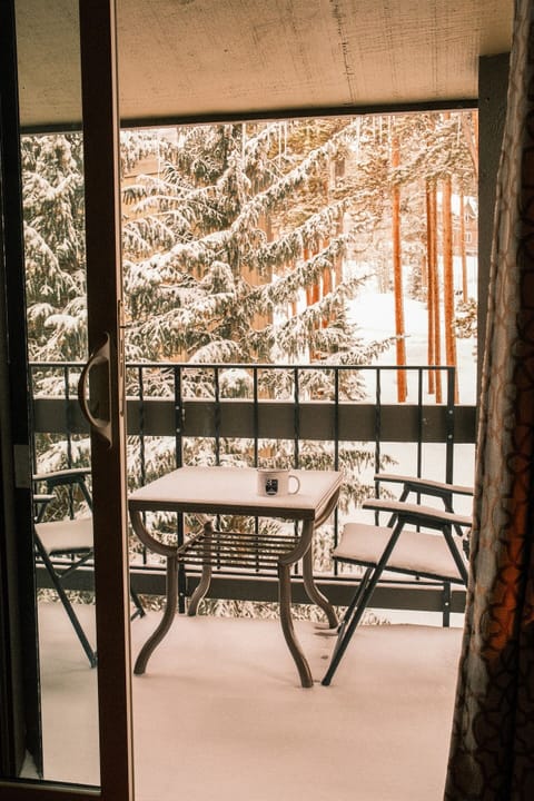 Marvel at the beautiful snowfall from the balcony near the top of the trees.