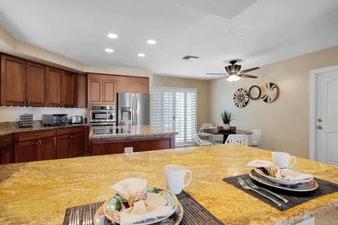 Seating for up to 12 guests between bar stools at the kitchen counter and two separate dining tables