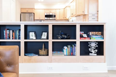 The bookcase includes books for adults and kids alike; collection of boardgames