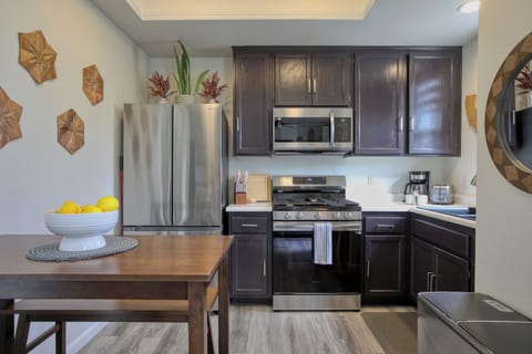 The fully equipped kitchen has a refrigerator, stove and oven, microwave, coffee maker, and dish ware—everything you need to whip up meals or enjoy a fresh cup of coffee before heading to the beach.