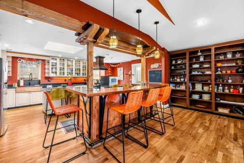 Inviting Kitchen Bar & Open Shelving - This stylish kitchen bar offers seating for six, perfect for gathering and entertaining. Open shelving adds charm and functionality, while warm wood accents create a cozy and welcoming atmosphere.