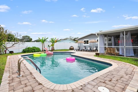 Refreshing pool with inflatables and sun loungers