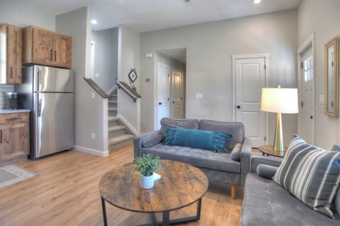 Open living room and kitchen - The main floor with living room, kitchen, queen bedroom and bathroom. Head upstairs to access the back patio and second and thrid bedrooms as well as the second bathroom and stackable washer and dryer.