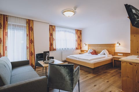 Comfort Quadruple Room, Balcony, Mountain View | Living area | TV