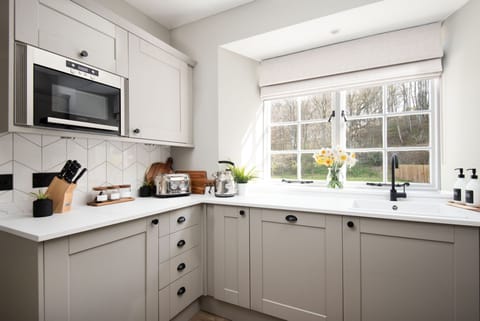 Honeysuckle Cottage - the smart shaker style kitchen with garden views
