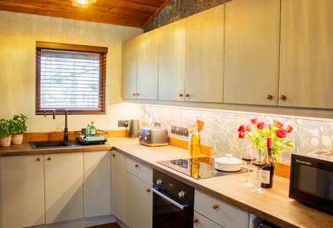 Stylish kitchen in Telford Cottage with flowers 