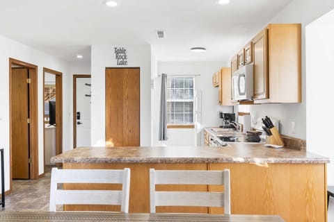 The open, airy kitchen offers ample space & every home comfort