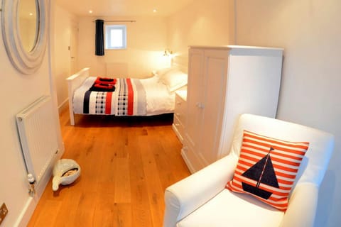 King size bedroom with armchair and wardrobe