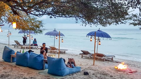 On the beach, white sand, sun loungers, beach umbrellas