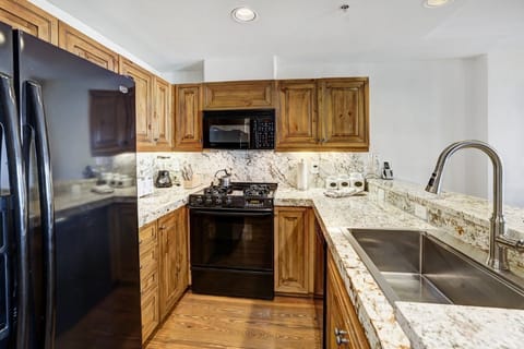 Modern kitchen design with granite counters and spacious cabinets.