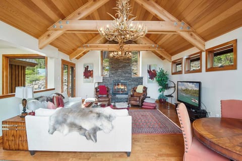 Luxurious living room with wood burning fireplace, flat screen TV
