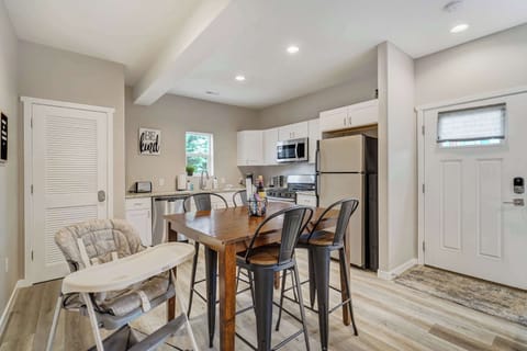 Inviting dining area with seating for four, a high chair for little ones, and an open flow to the fully equipped kitchen.