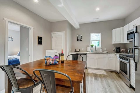 Inviting dining area with a stocked kitchen, featuring modern appliances and thoughtful touches to make mealtime a breeze.