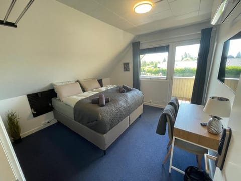 Desk, laptop workspace, blackout drapes, iron/ironing board