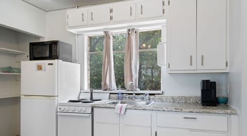 This tiny kitchen is whisking you away. Meals, mugs, and microwave dreams await!