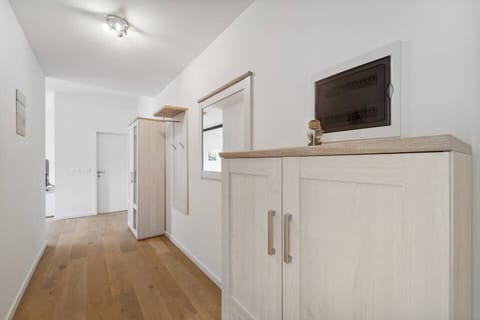 Der helle Eingangsbereich mit Garderobe und Spiegel sorgt für einen freundlichen Empfang und praktischen Stauraum.