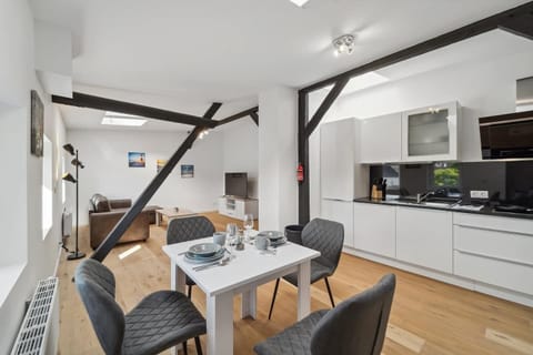 Die helle Wohnküche mit offenem Essbereich, moderner Ausstattung und gemütlicher Sitzecke schafft eine einladende Atmosphäre.