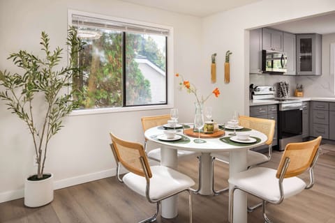 Enjoy meals in a bright and airy dining area, with seating for the whole group. The minimalist design and beautiful greenery outside the window create a refreshing dining experience.